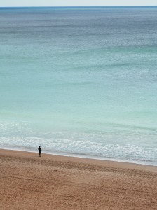Fisherman on crowded Algarve beach