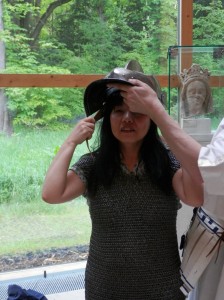 Rieko in chain mail tabard, trying on helm